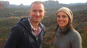 Smiling couple with view of red rocks on a Sedona Vortex couples retreat